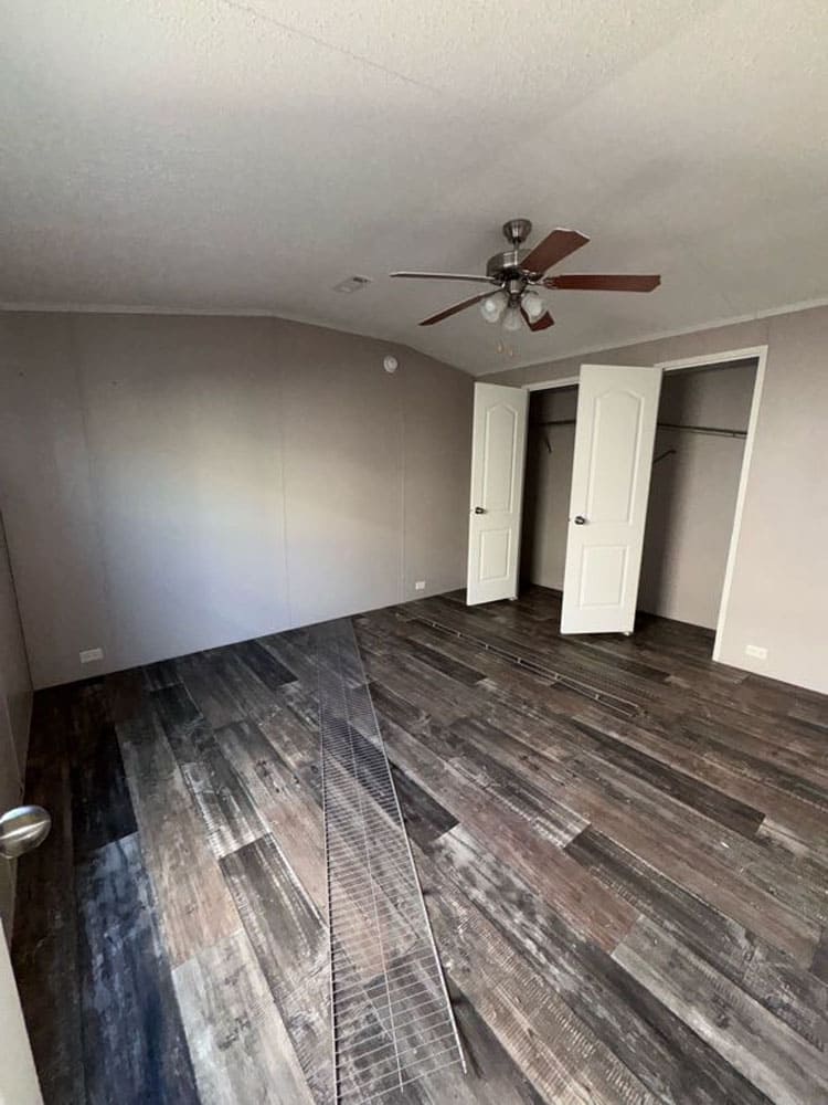 Primary bedroom with double closets and ceiling fan in The Leyla