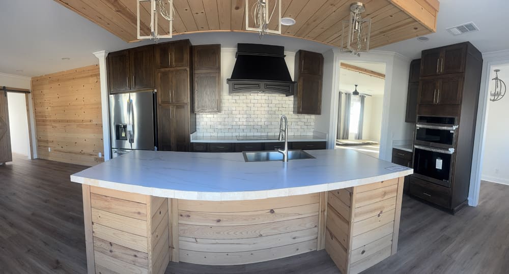 Large kitchen island with stainless appliances at Premier Homes of Conroe