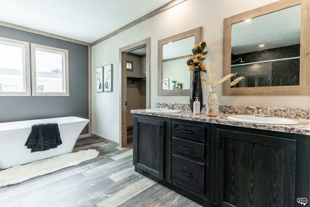 Primary bathroom with double vanity and freestanding tub