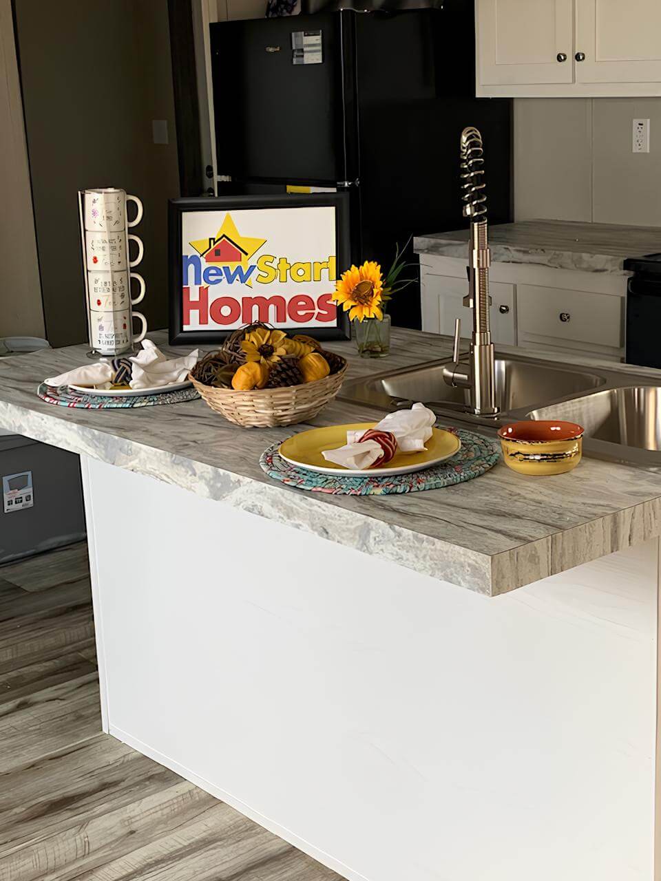 Kitchen island with farmhouse sink in The Cuatro in Greenville, TX
