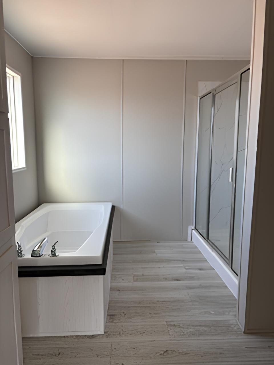 Primary bath with soaking tub and separate shower in 32x76 manufactured home