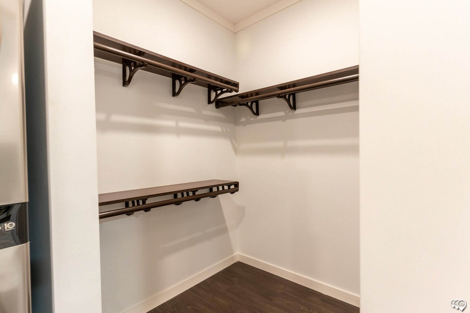 Walk-in closet with wraparound wood shelving in The Trinity CS-3242