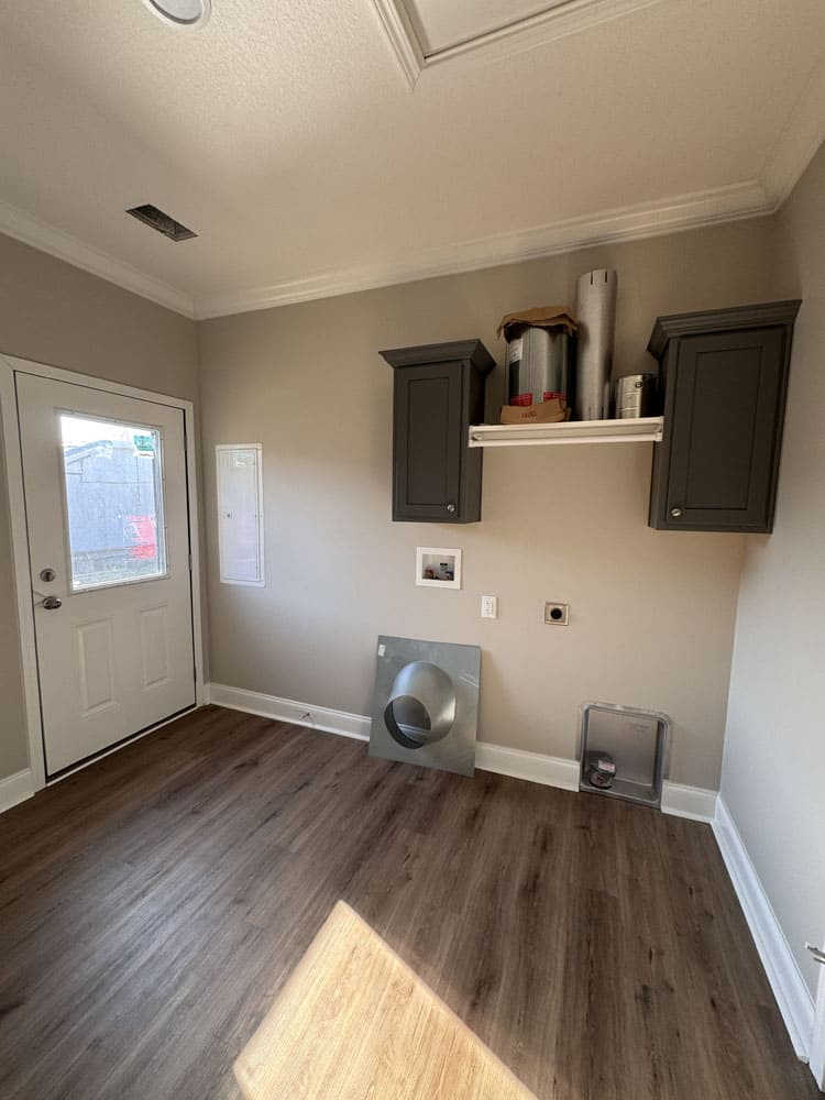 Laundry and mudroom with exterior door in The Lilly II modular home for sale near Conroe, Texas