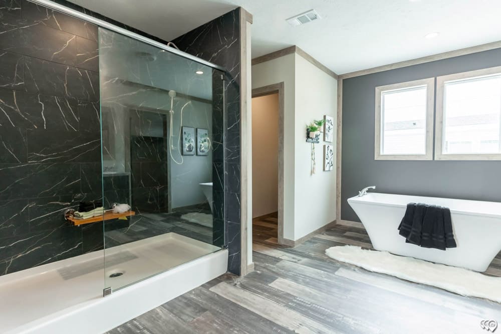 Luxury shower and soaking tub in The Shoal Creek by Timber Creek Housing