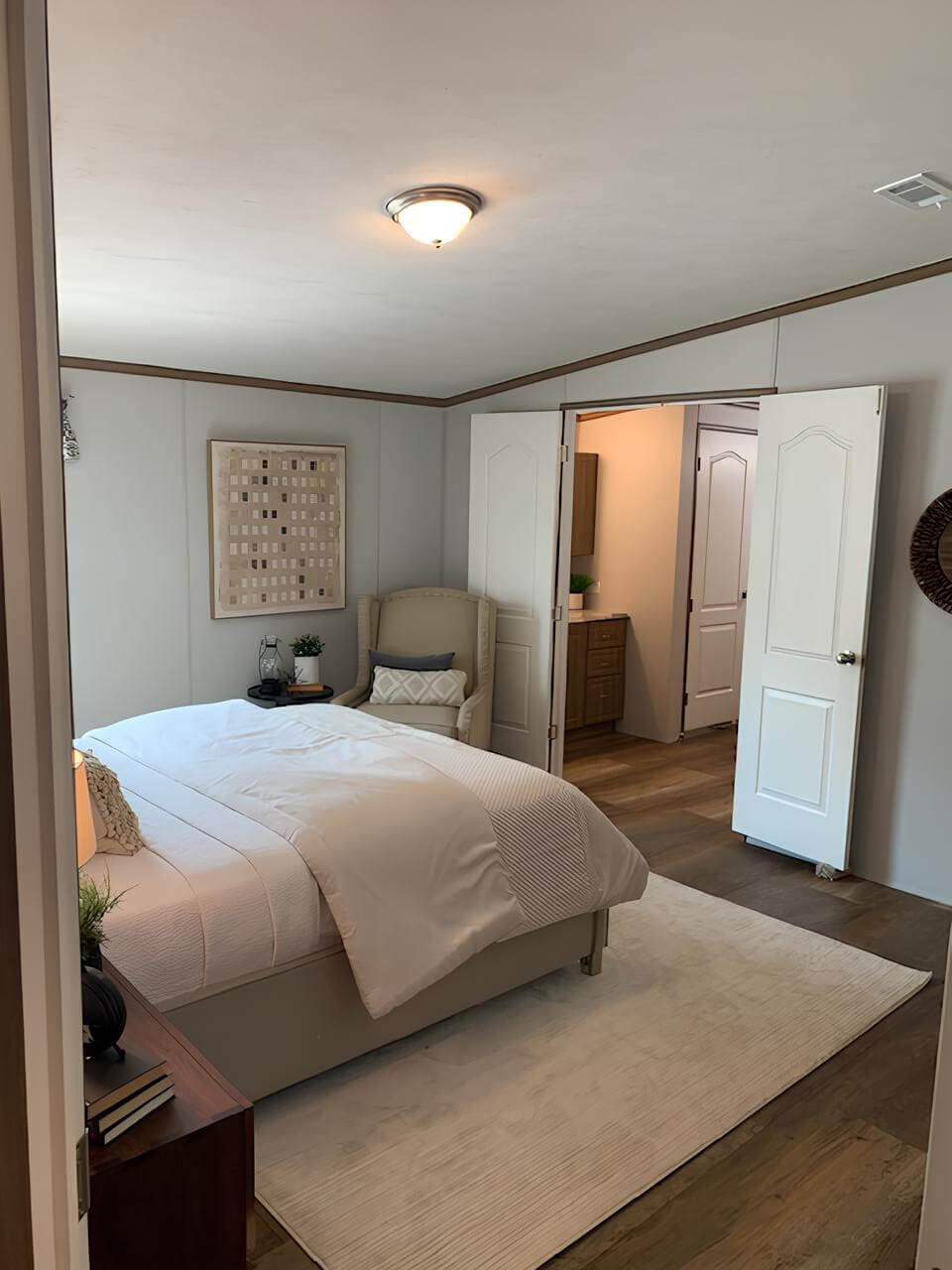 Primary bedroom with ensuite access in The Lakehouse by Legacy Housing
