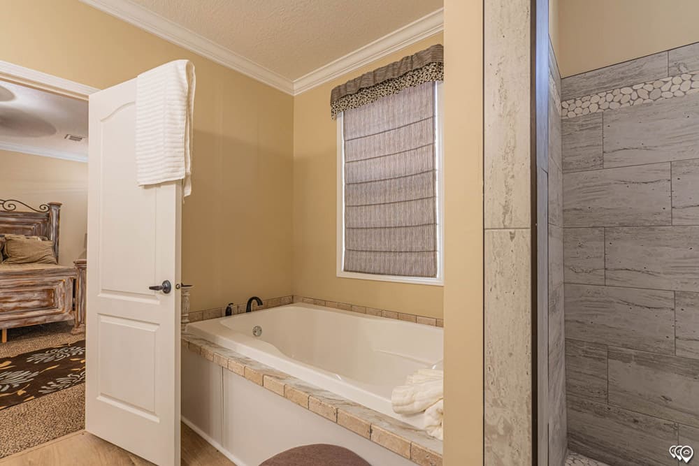 Primary bath with soaking tub and tiled walk-in shower