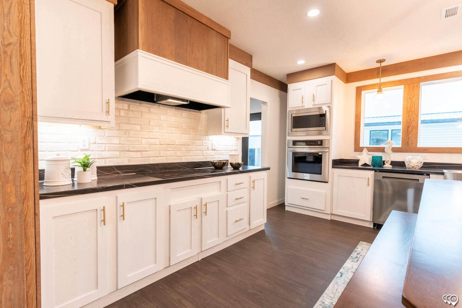 Kitchen cooking area with brick-style backsplash in The Trinity CS-3242