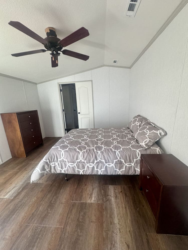 Primary bedroom with vaulted ceiling in a large singlewide home