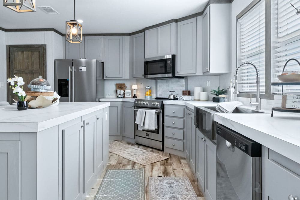 Modern kitchen with island and stainless appliances in The Murphy