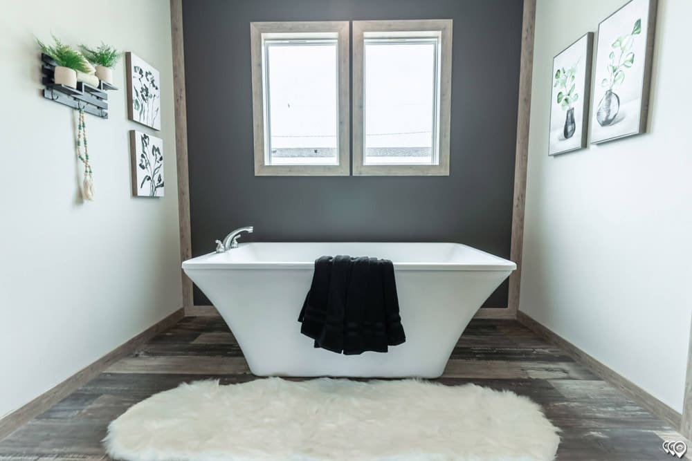 Freestanding soaking tub in The Shoal Creek primary bathroom