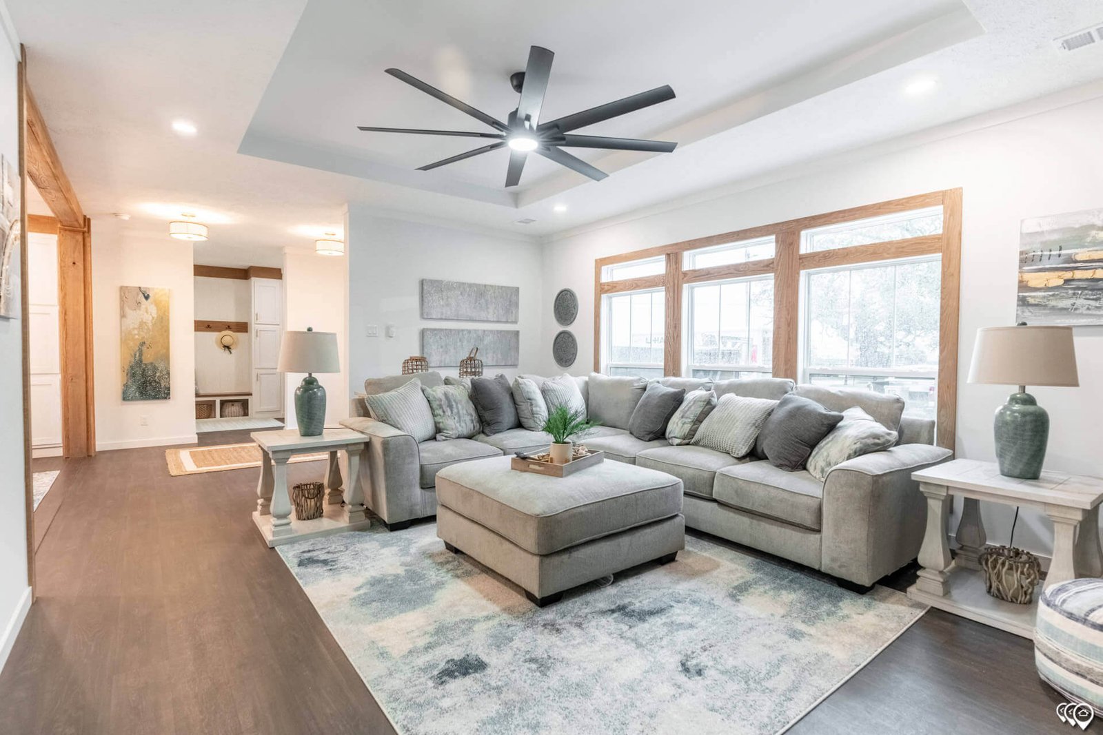 Spacious living room with large windows and tray ceiling in The Trinity CS-3242