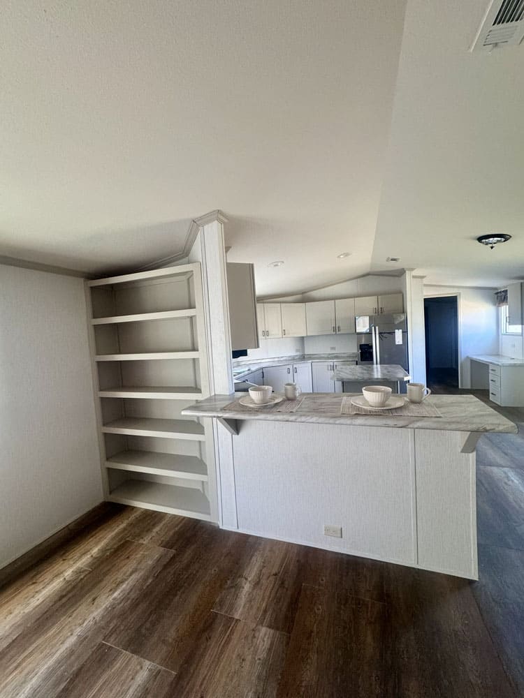 Built-in dining shelves and breakfast bar in a Conroe mobile home for sale