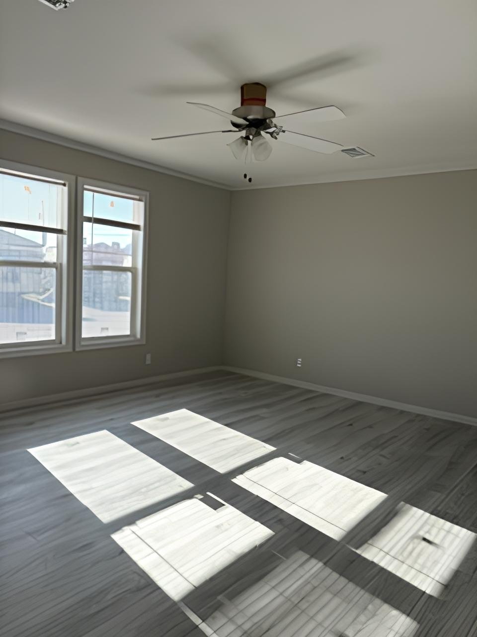 Large bedroom with ceiling fan in used Midland TX doublewide
