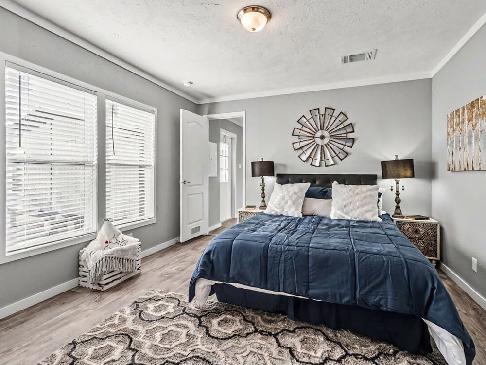 Furnished bedroom with two windows in the Bobby Jo 16x66 single-wide home