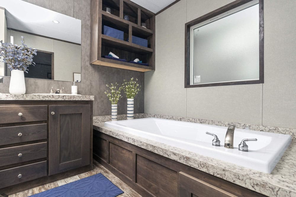 Primary bathroom soaking tub and storage in The Grant