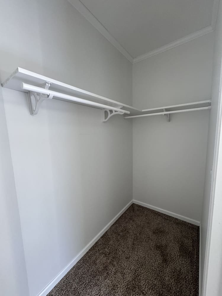 Walk-in bedroom closet in The Shoreline home at Premier Homes of Conroe