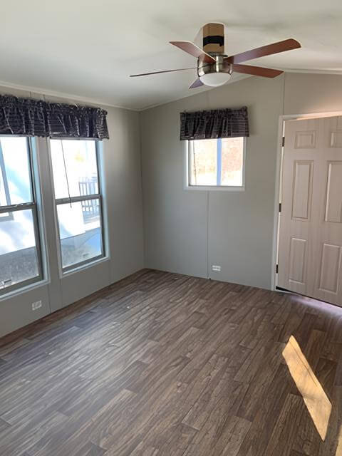 Bright Tiny Hacienda living room with ceiling fan and large windows