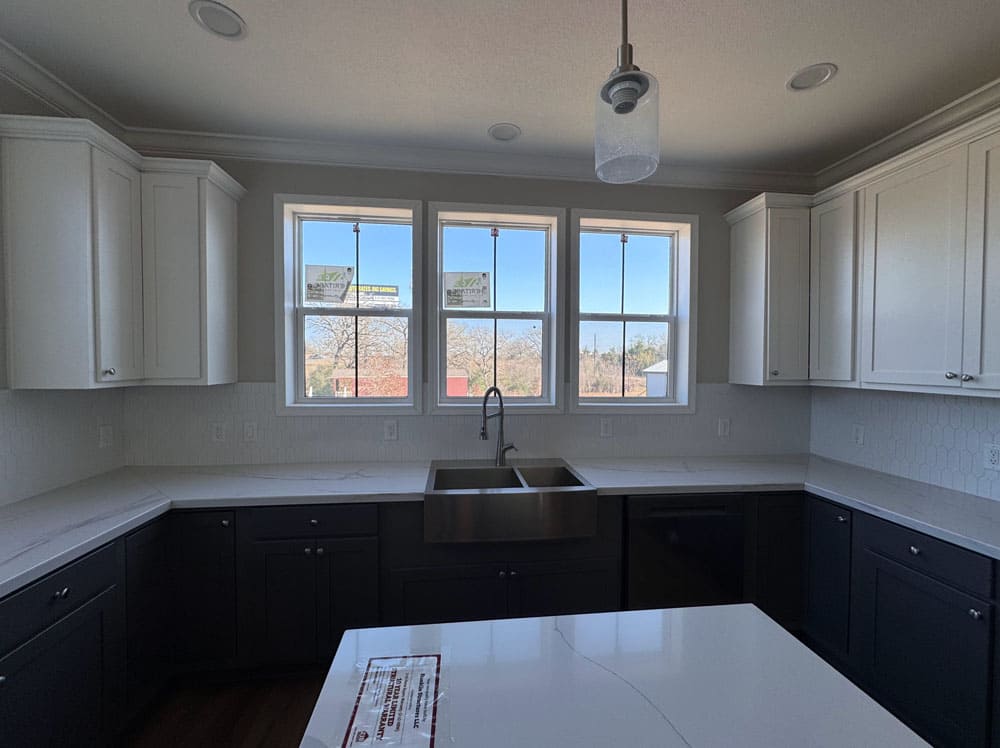 Farmhouse sink beneath three windows in this Franklin Homes modular home for sale at Premier Homes of Conroe