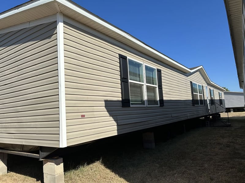 Front and side exterior of pre-owned #61 2023 Clayton 28x76 double-wide in Tyler, Texas