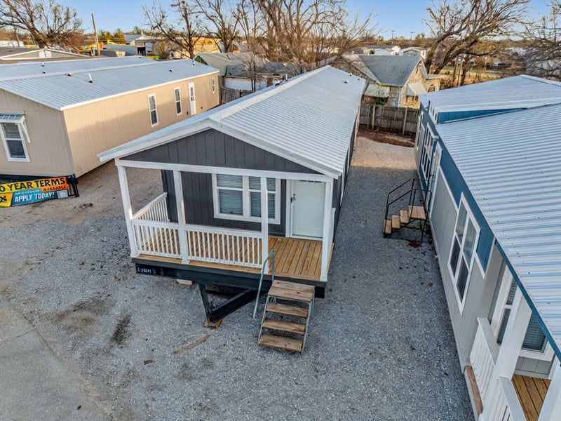 Aerial exterior view of the Bobby Jo 16x66 home with its built-in front porch