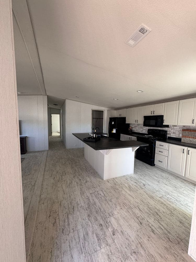 Modern kitchen and central island in The Lucia doublewide