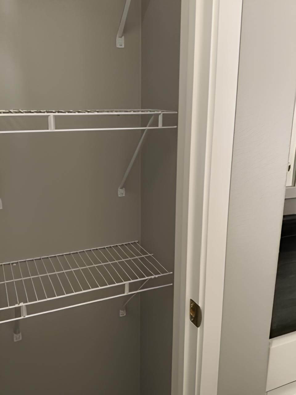 Linen closet with wire shelving in the Bobby Jo two-bedroom home