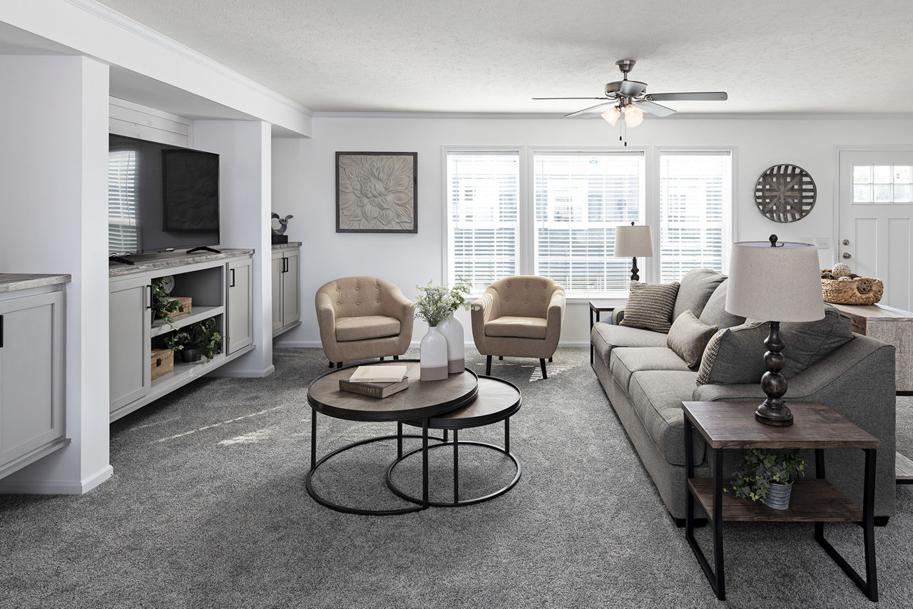 Living area in The Odyssey XL 3256 by Champion Homes