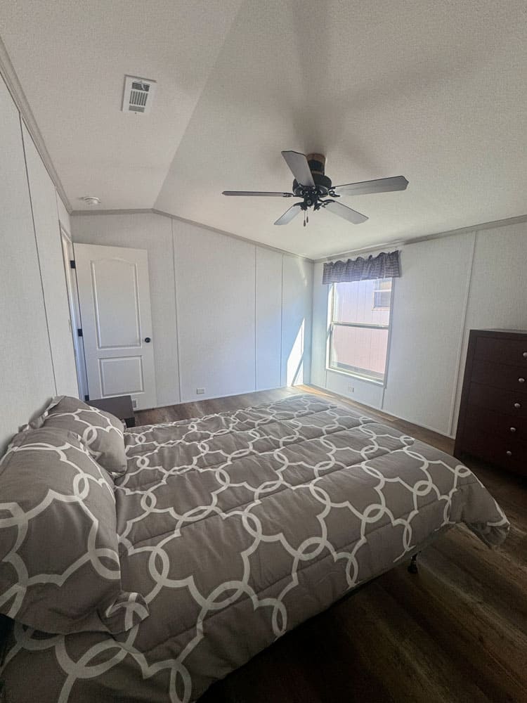 Bright primary bedroom in the H-1880-32E manufactured home near Conroe