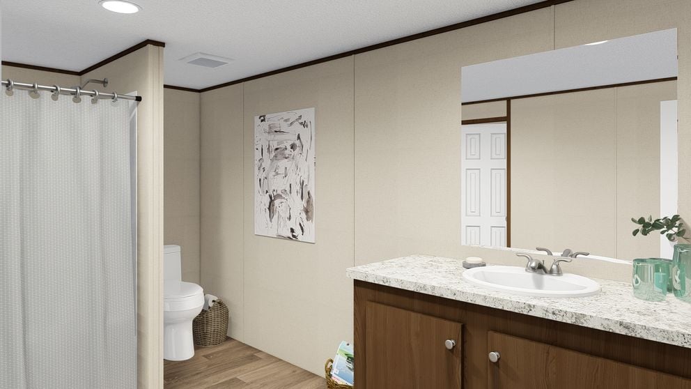 Primary bathroom with dual sinks and walk-in shower in The Thrill by TRU Homes