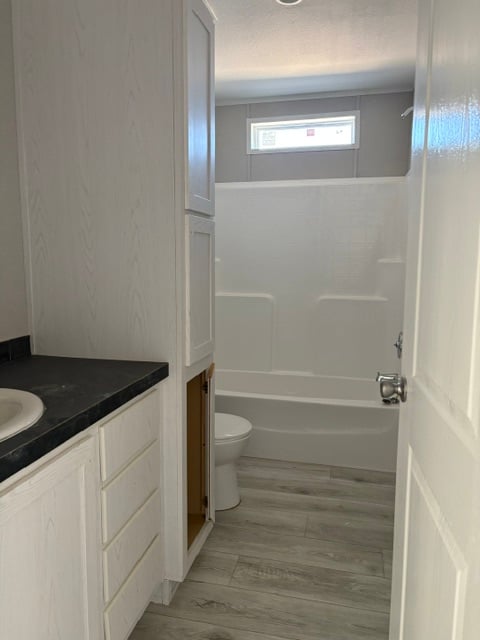Guest bathroom with tub shower and vanity in Midland TX manufactured home