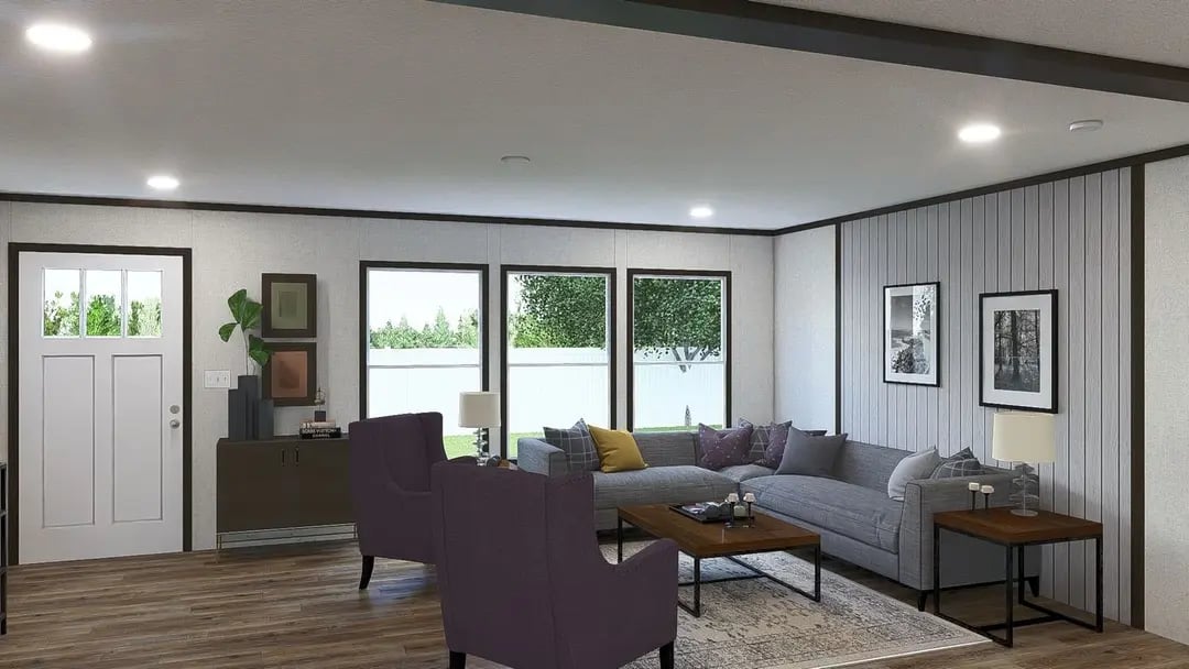 Spacious living room with large windows in this 4-bedroom manufactured home