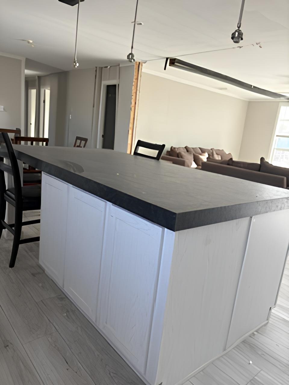Oversized kitchen island overlooking living area in Midland manufactured home
