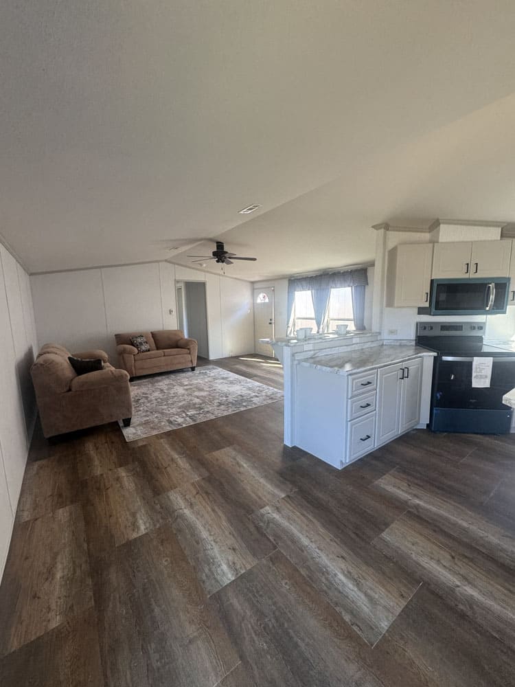 Open-concept kitchen and living room in a 3 bedroom manufactured home near Conroe, Texas