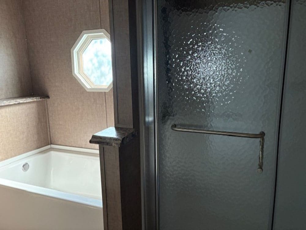 Primary bathroom soaking tub and separate shower in The Leslie