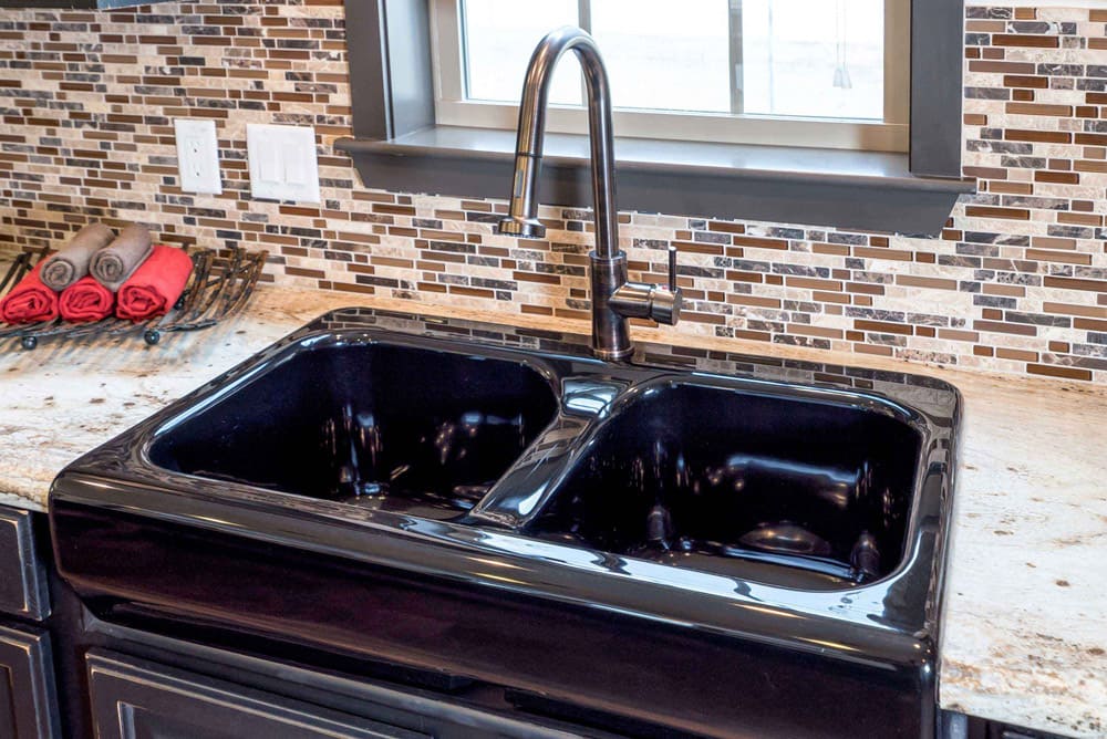 Double-basin kitchen sink and mosaic backsplash in The Nandina