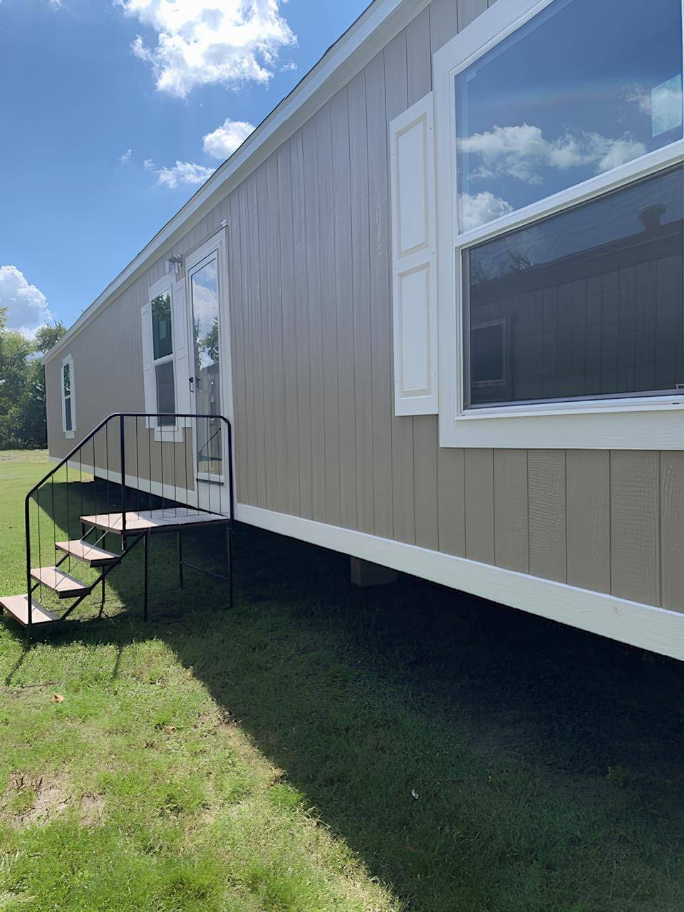 Side exterior of The Colossal Ultrawide manufactured home in Bonham, TX