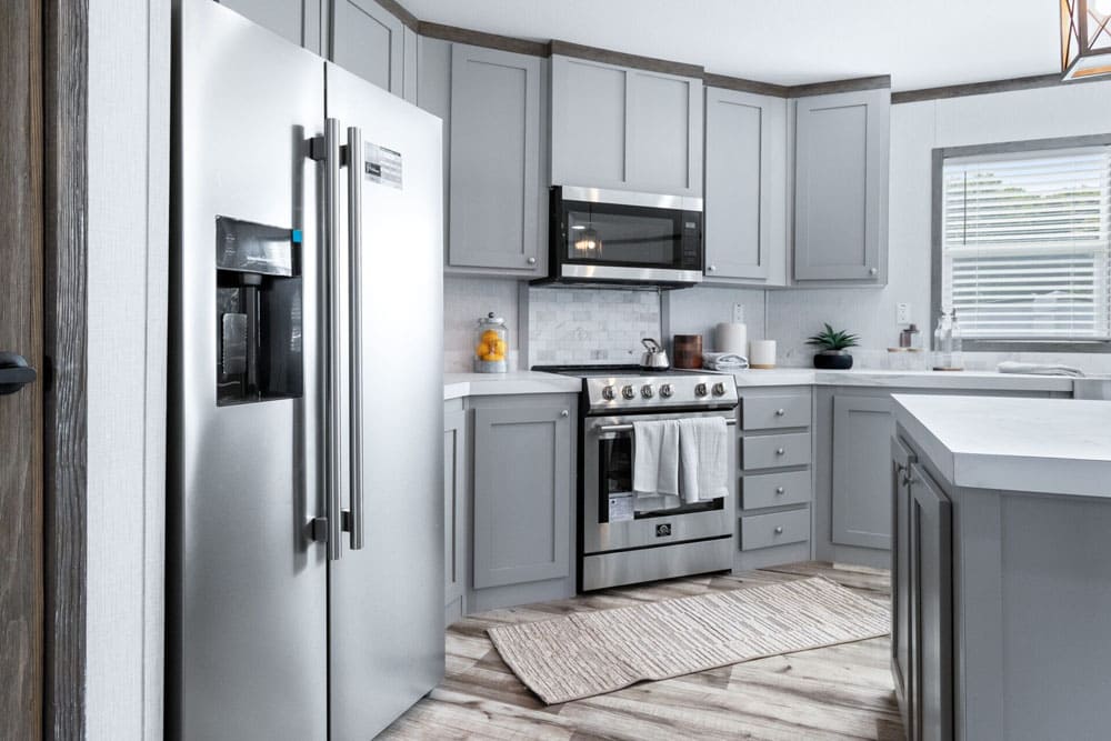 Gray kitchen cabinets and stainless appliances in Jessup Housing model ELT32764A