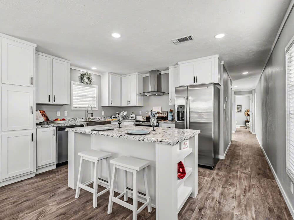 Bobby Jo kitchen with white cabinets, stainless steel appliances, and an island