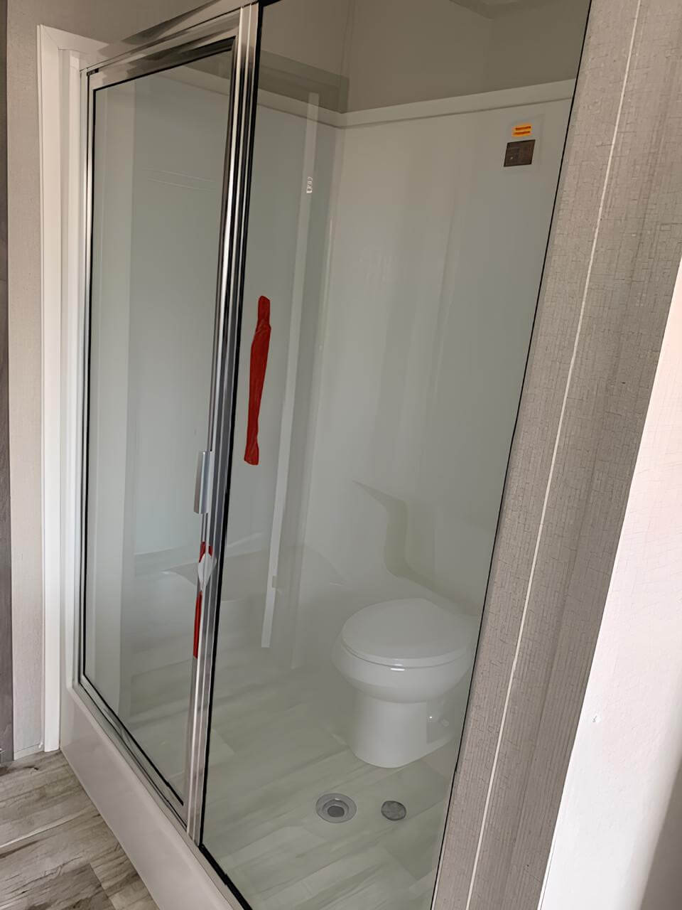 Glass-door shower in The Cuatro manufactured home bathroom