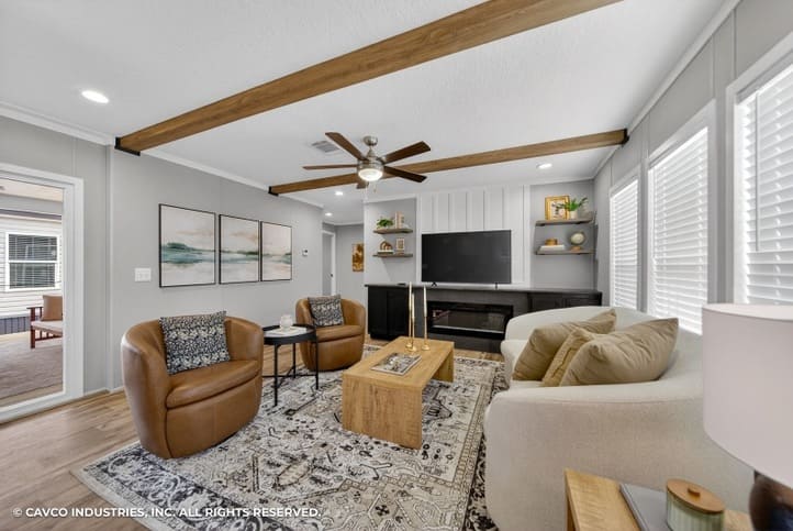 Bright living room with exposed beams in The Vantage manufactured home