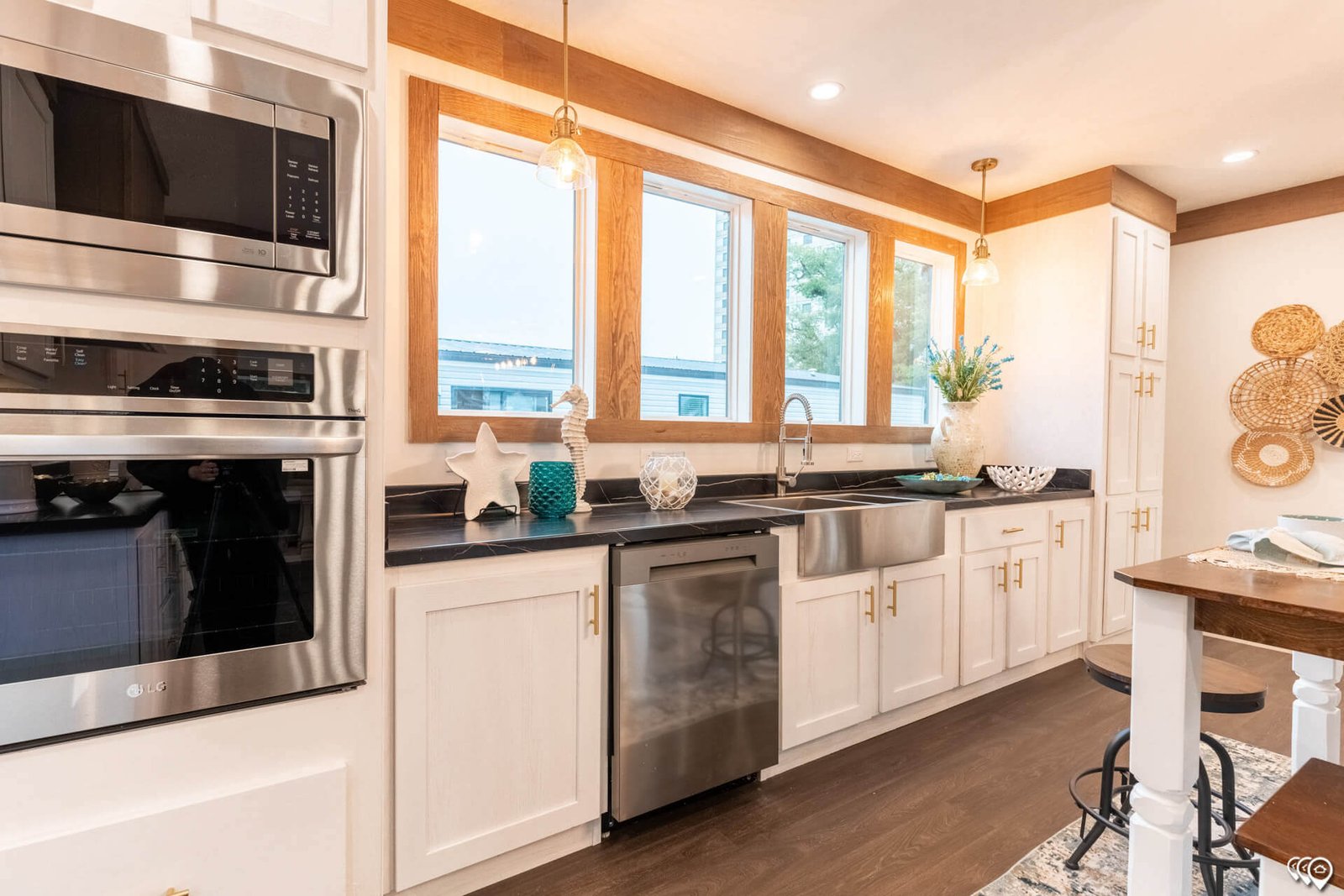 Kitchen sink wall with stainless steel appliances in The Trinity CS-3242
