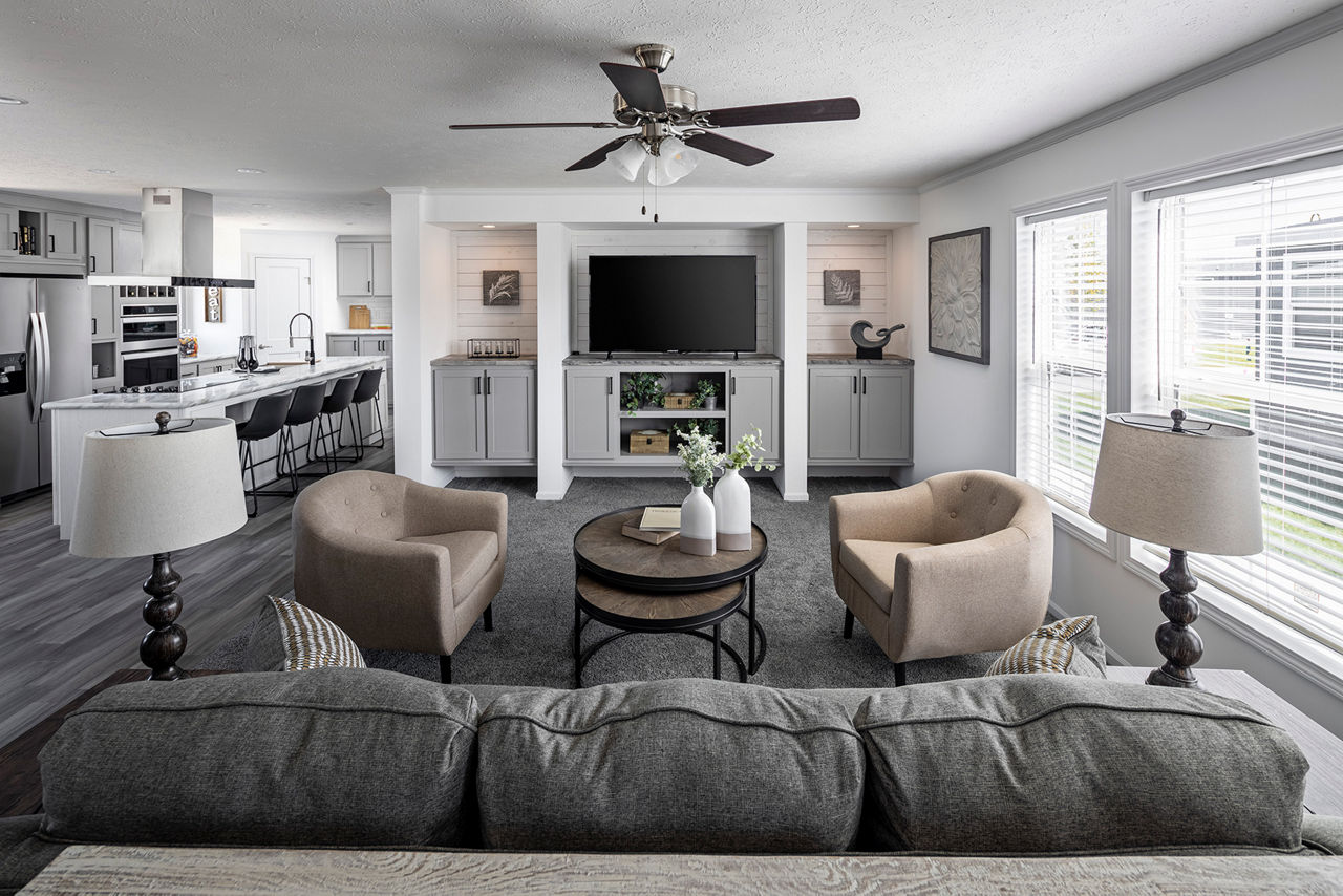 Bright family room inside The Odyssey XL 3256 mobile home