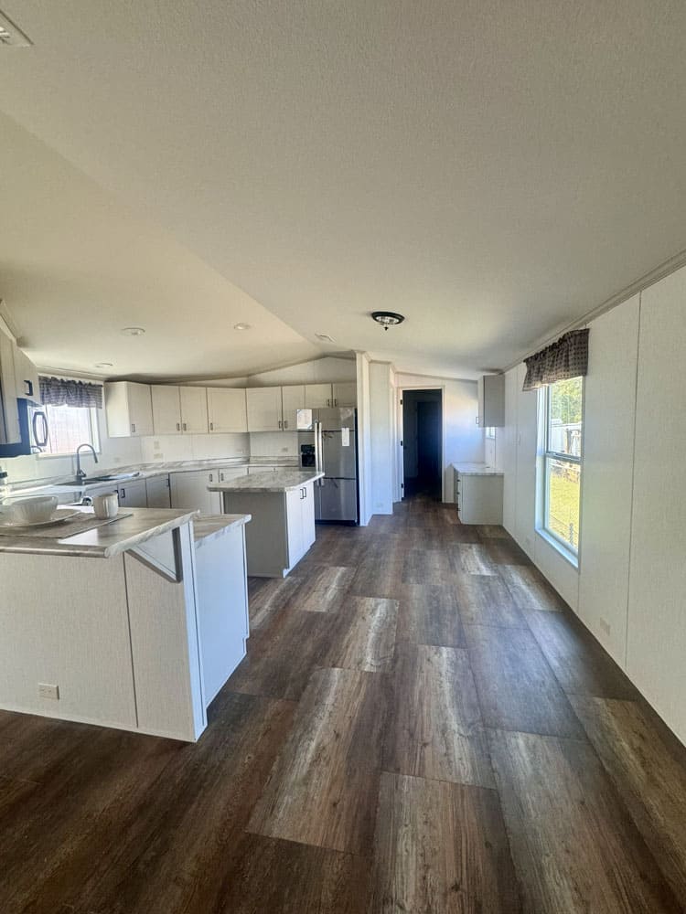 Roomy kitchen and dining area in the Legacy Housing H-1880-32E