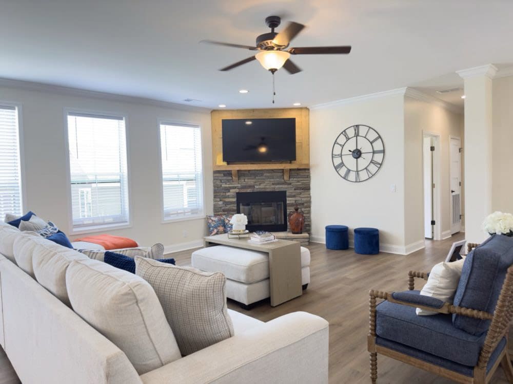 Living room with stone fireplace in The Riverwalk by Franklin Homes