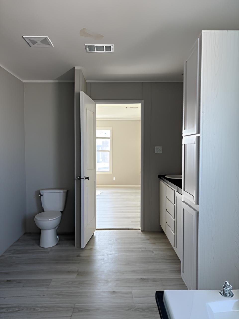 Primary bathroom vanity and storage in used doublewide #180