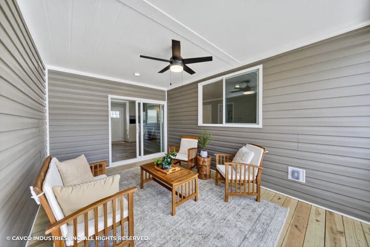 Covered porch with ceiling fan on the Cavco Vantage in Española, NM