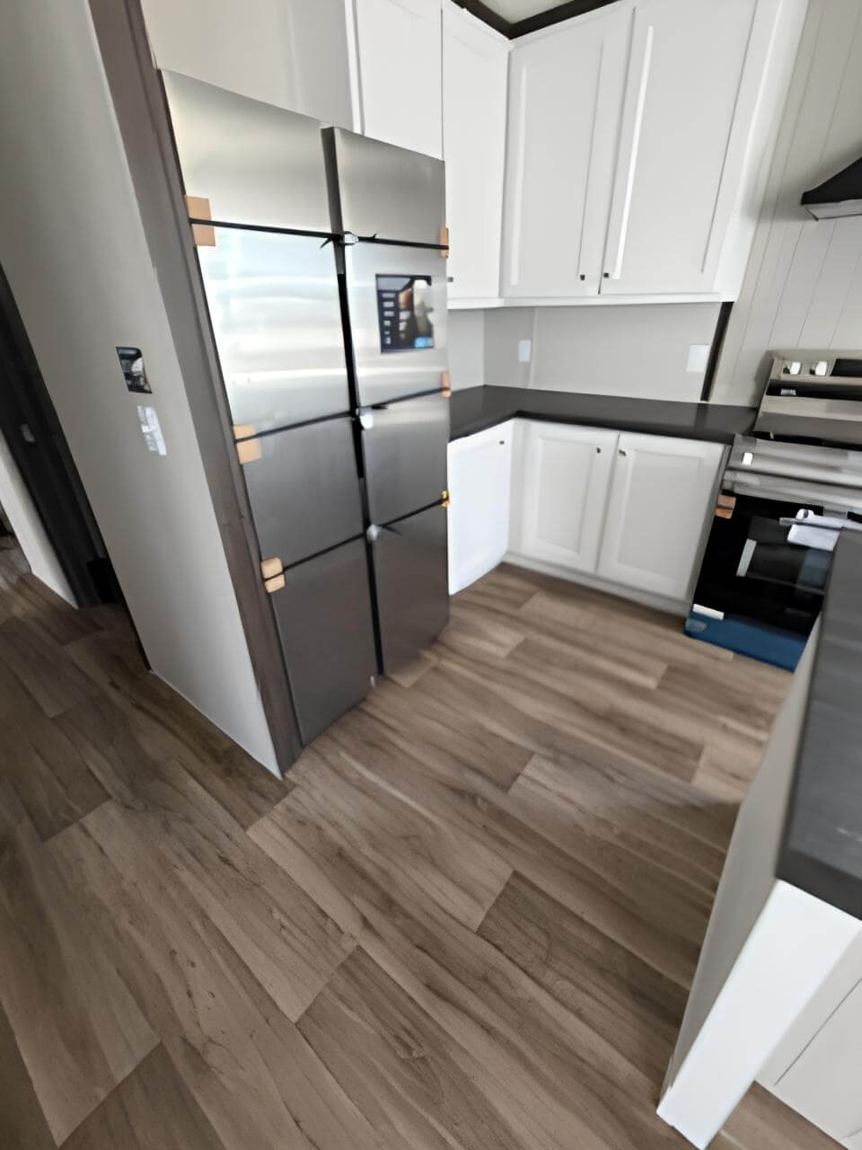 White-cabinet kitchen with stainless appliances in The Blitz