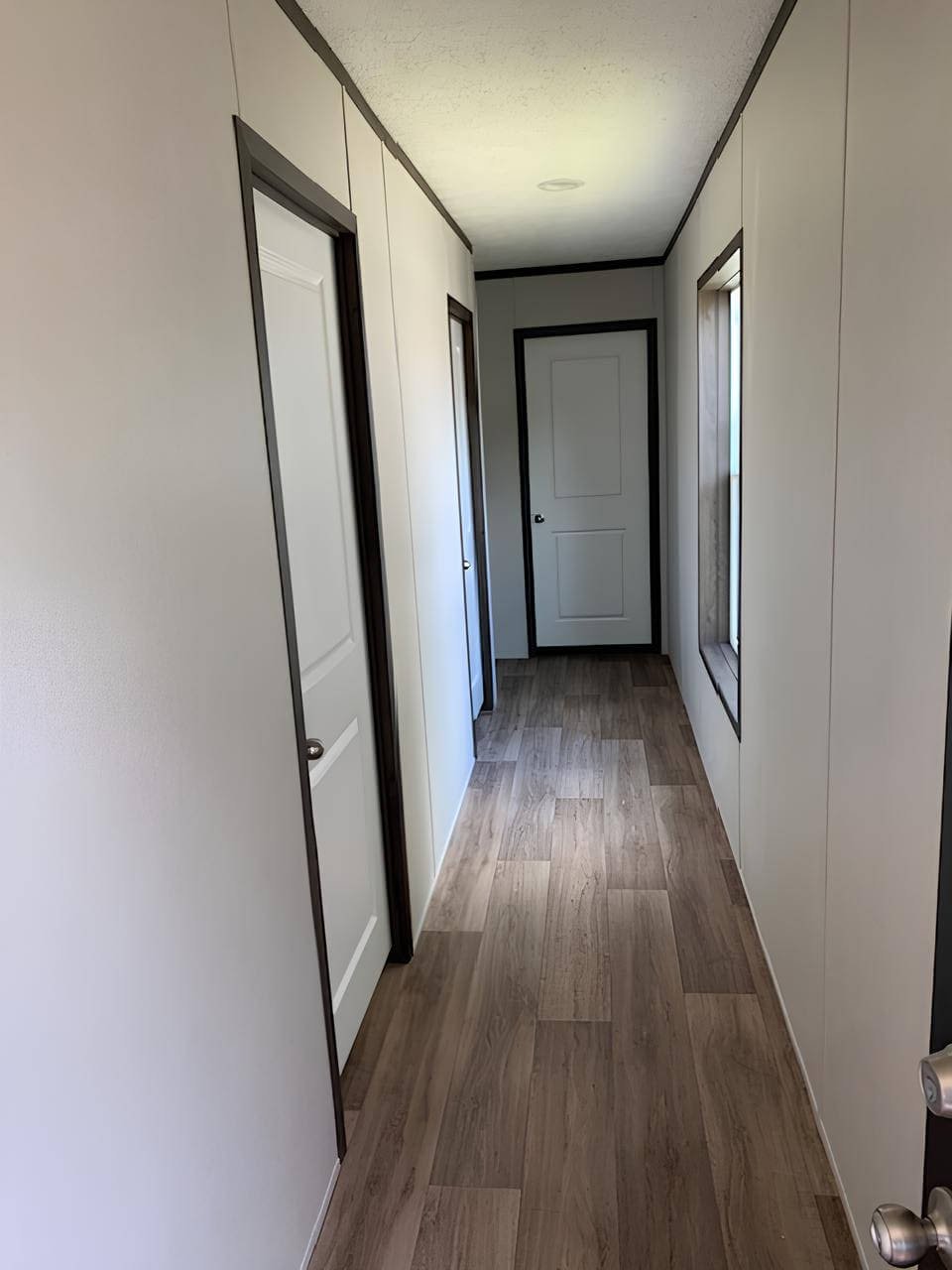 Central hallway with wood-look flooring in The Colossal Ultrawide
