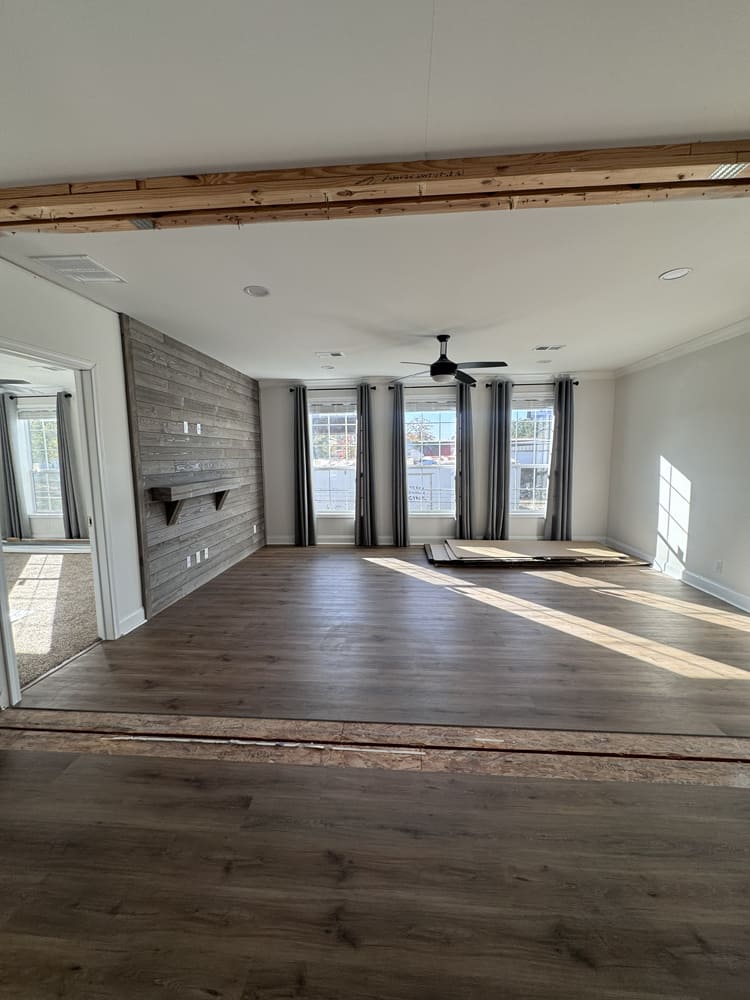 Sunlit living room with shiplap feature wall in The Shoreline by Franklin Homes