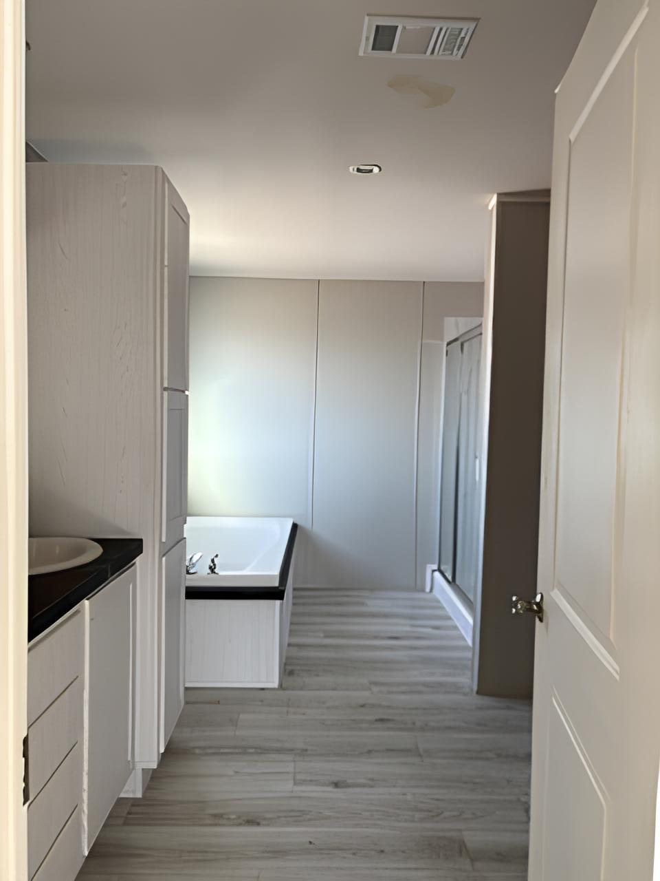 Spacious primary bathroom with soaking tub and shower in Midland doublewide